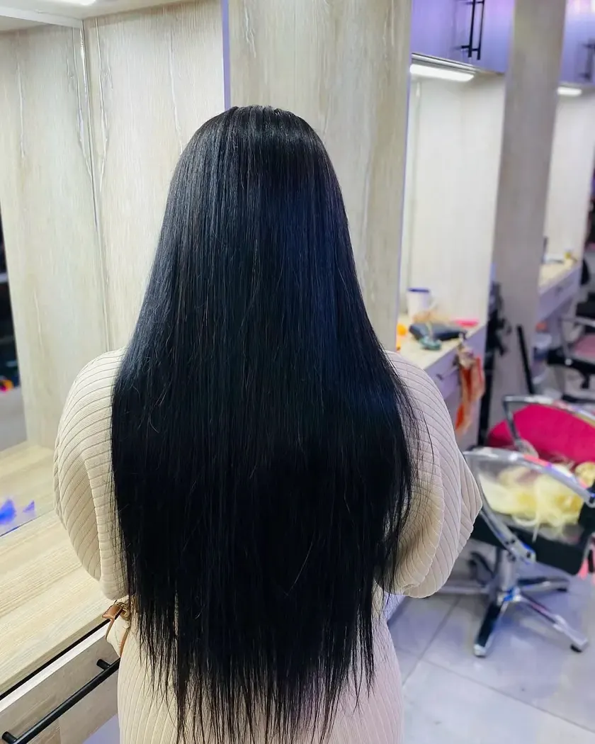 A long bone-straight install worn loose, from behind